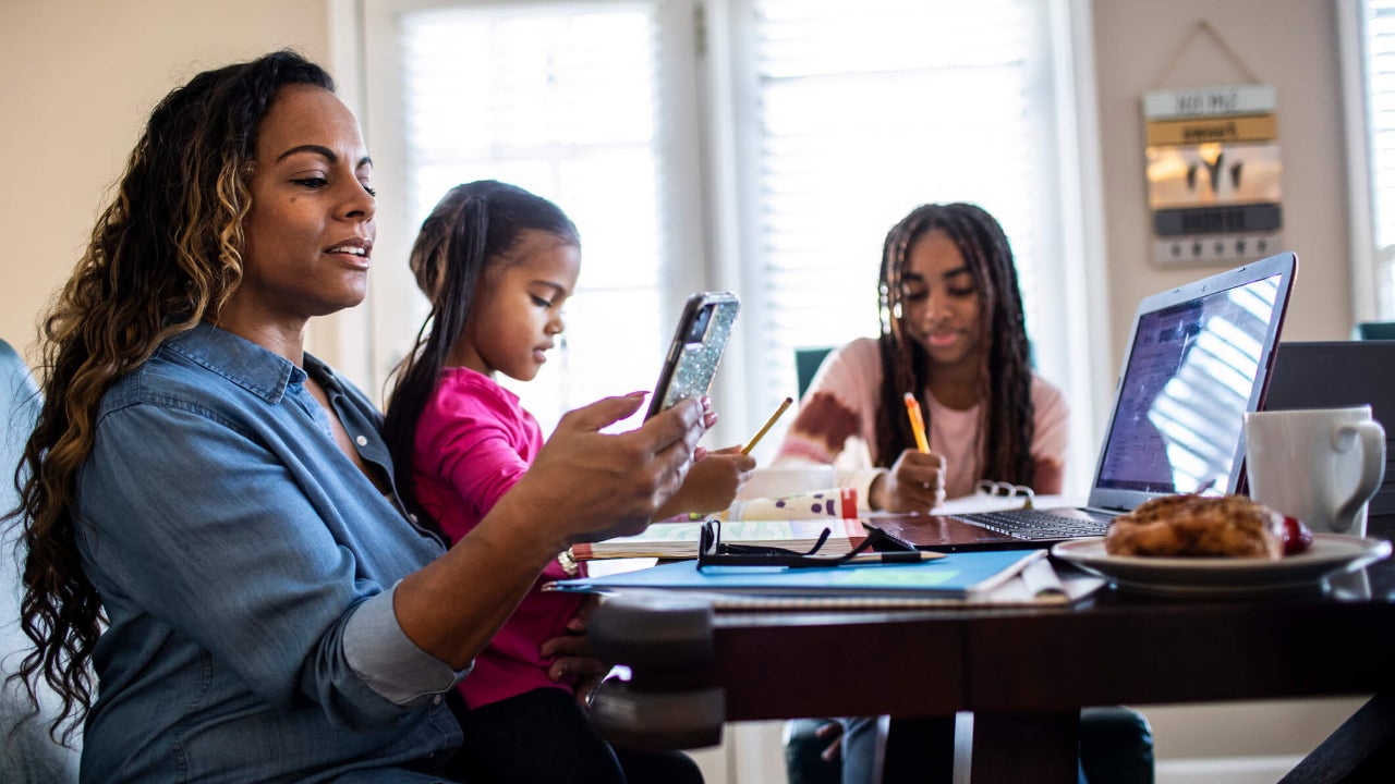 Mother working from home while daughters homeschool