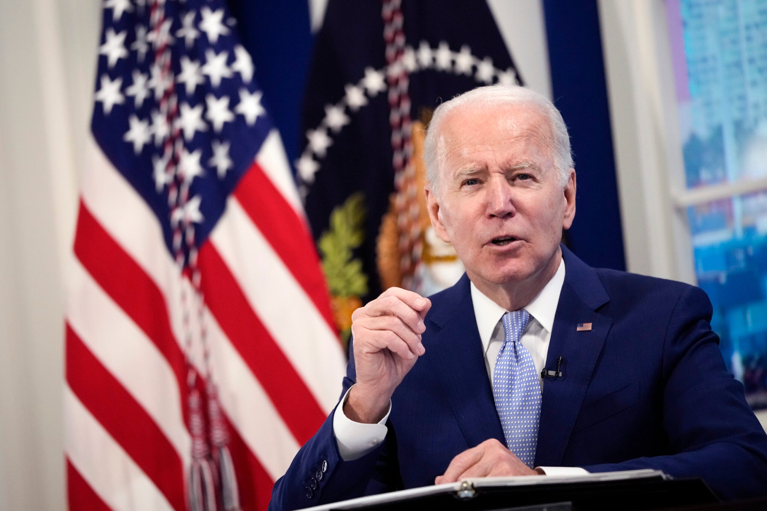 Biden stands at a podium.