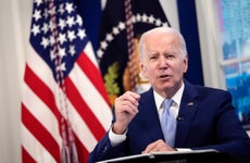 Biden stands at a podium.