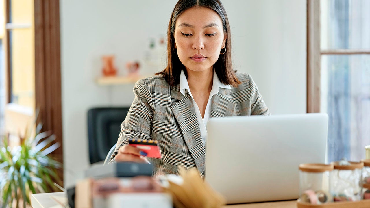 Woman using credit card for online payments