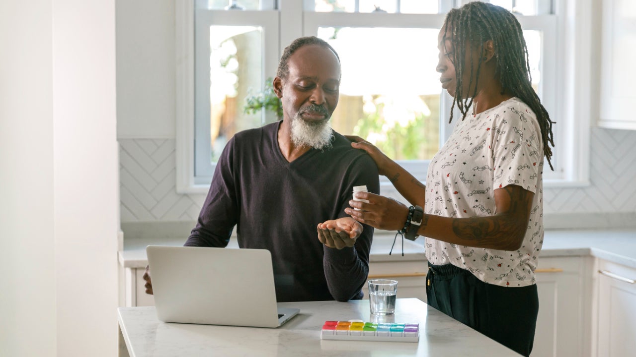 Senior couple meets with doctor on laptop