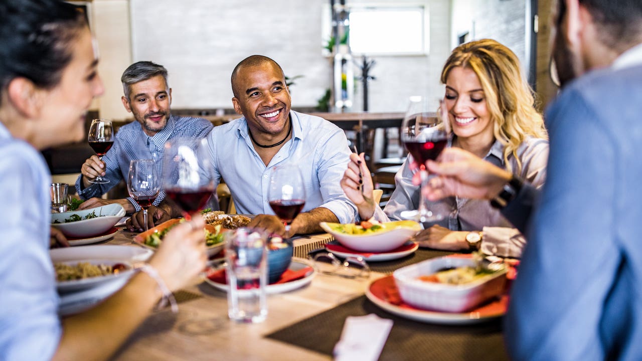 group of people eating a meal together at a restaurant