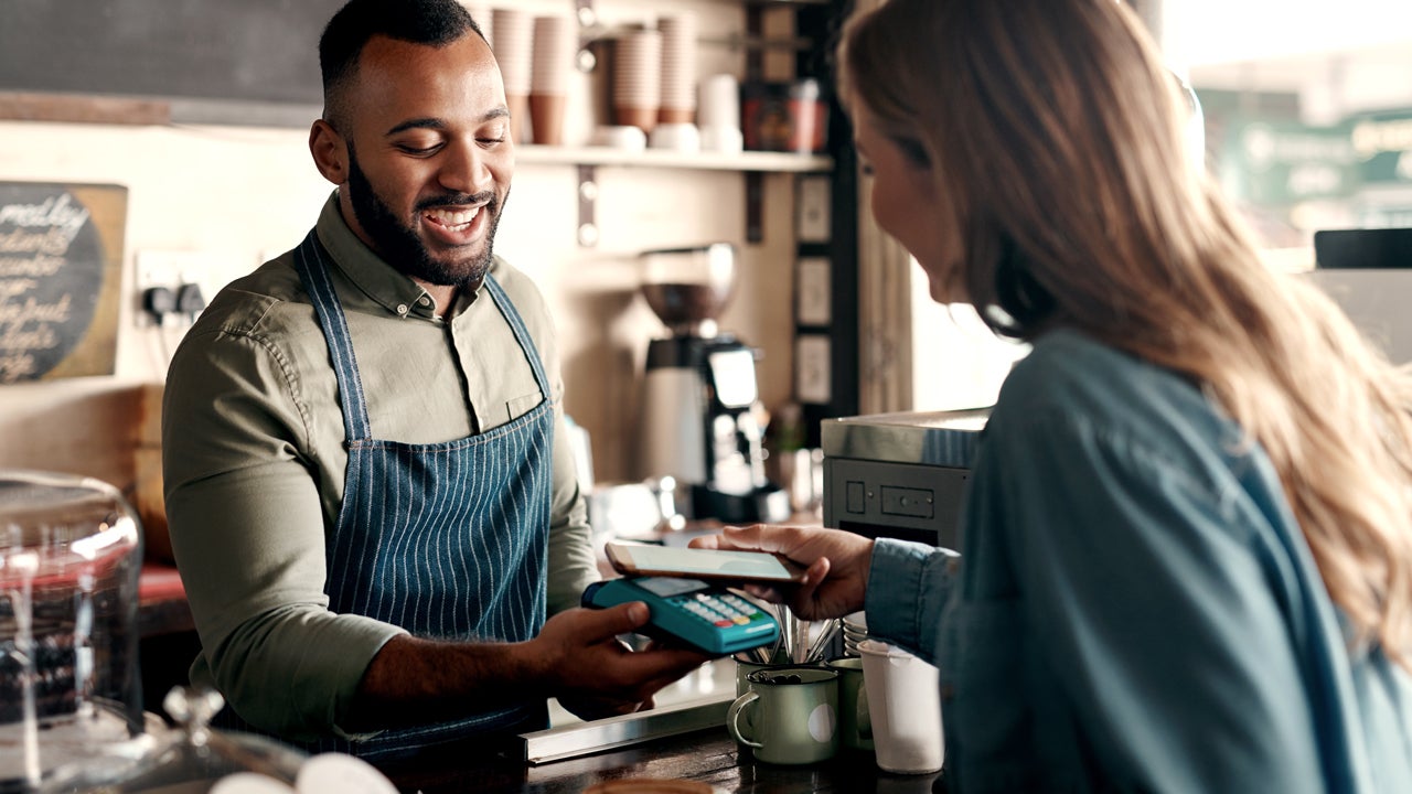 customer paying in a coffee shop