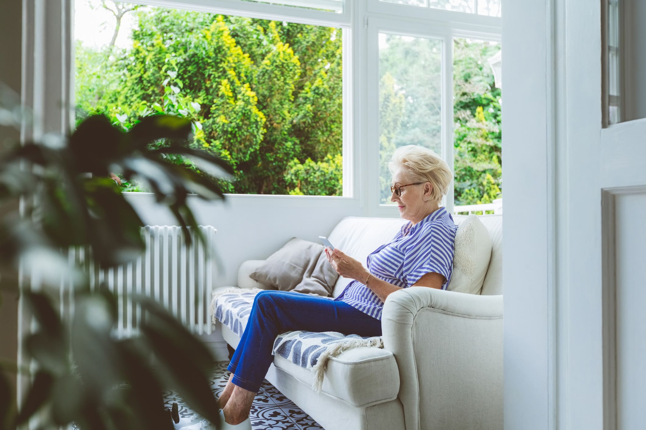 Senior woman using tablet PC at home