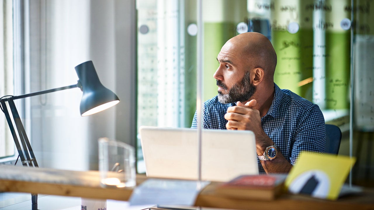 man in an office looking out the window