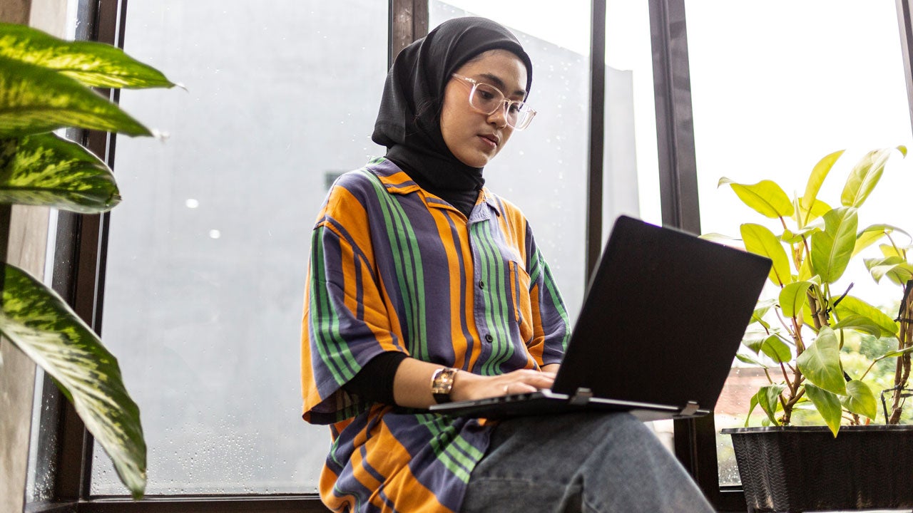 young woman working on her laptop