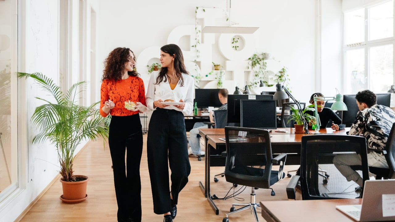 Two women walk through their office