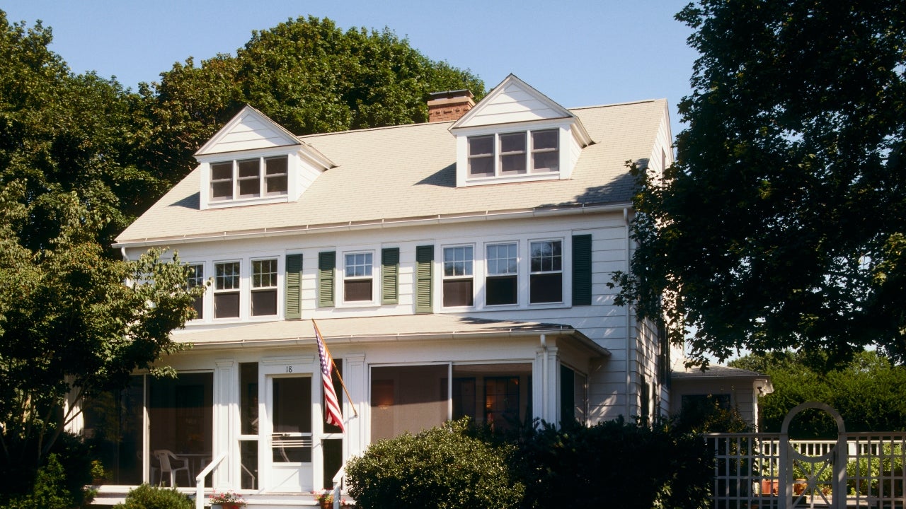 A two-story single-family home with screened-in porch