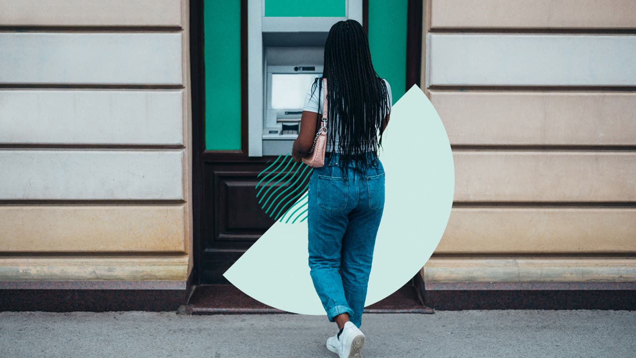 Woman walking up to an ATM