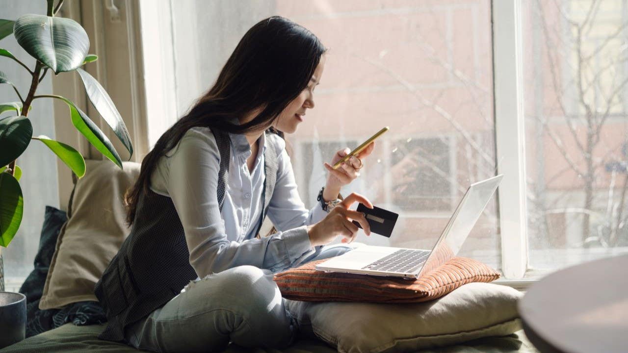 Woman online shopping on her computer and phone.