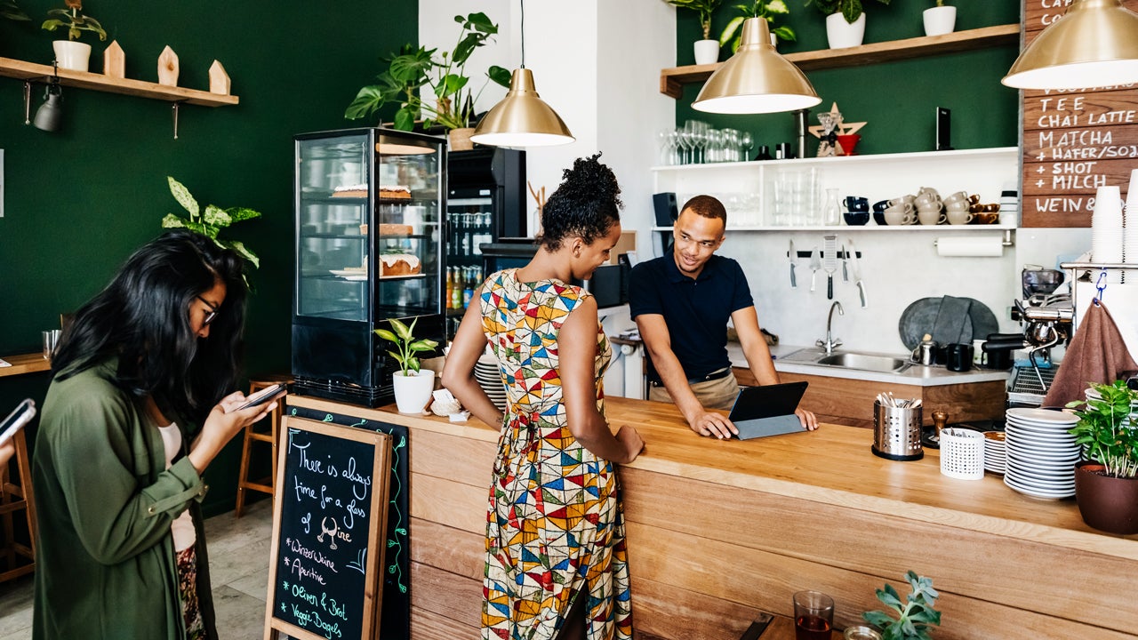 young person at counter checking out at a restaurant