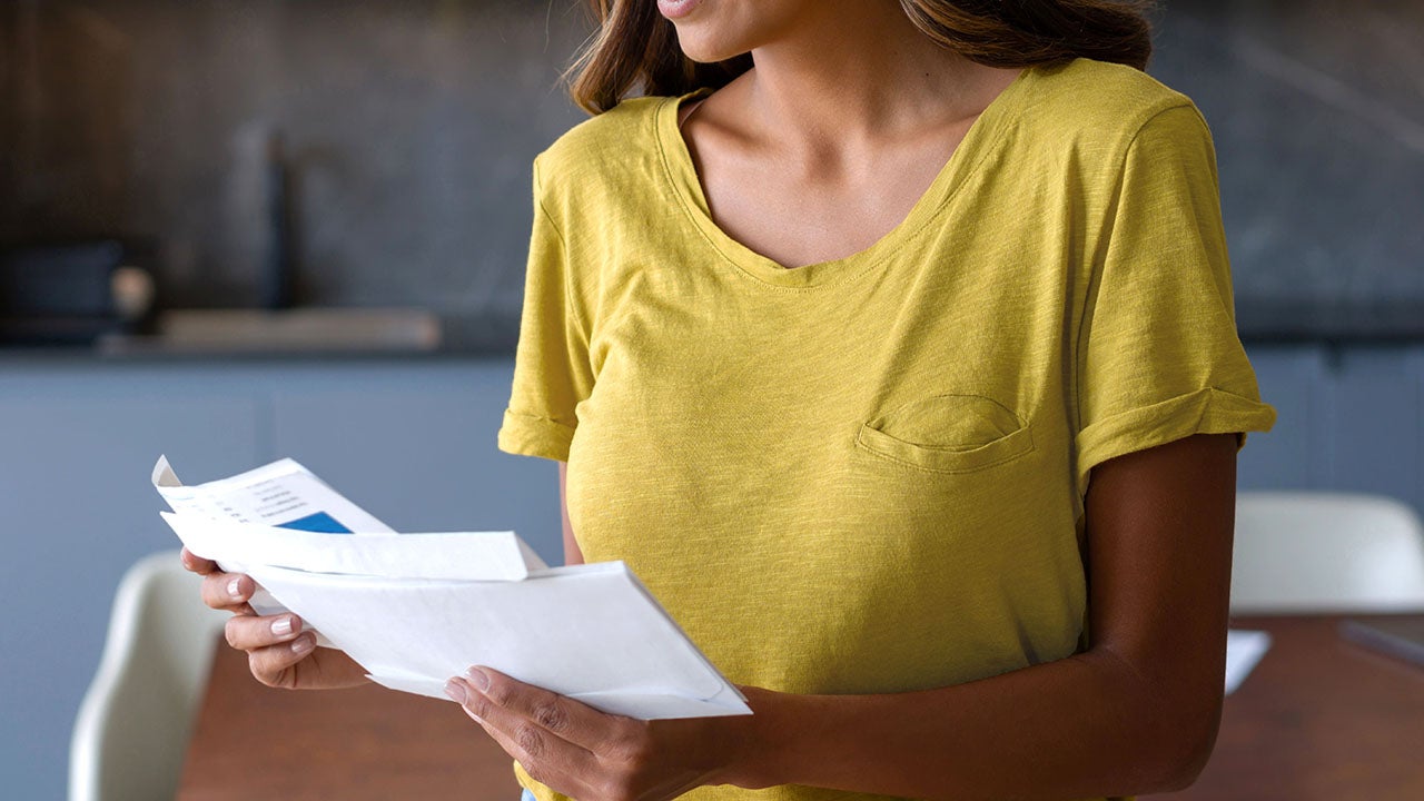 Woman at home checking the mail