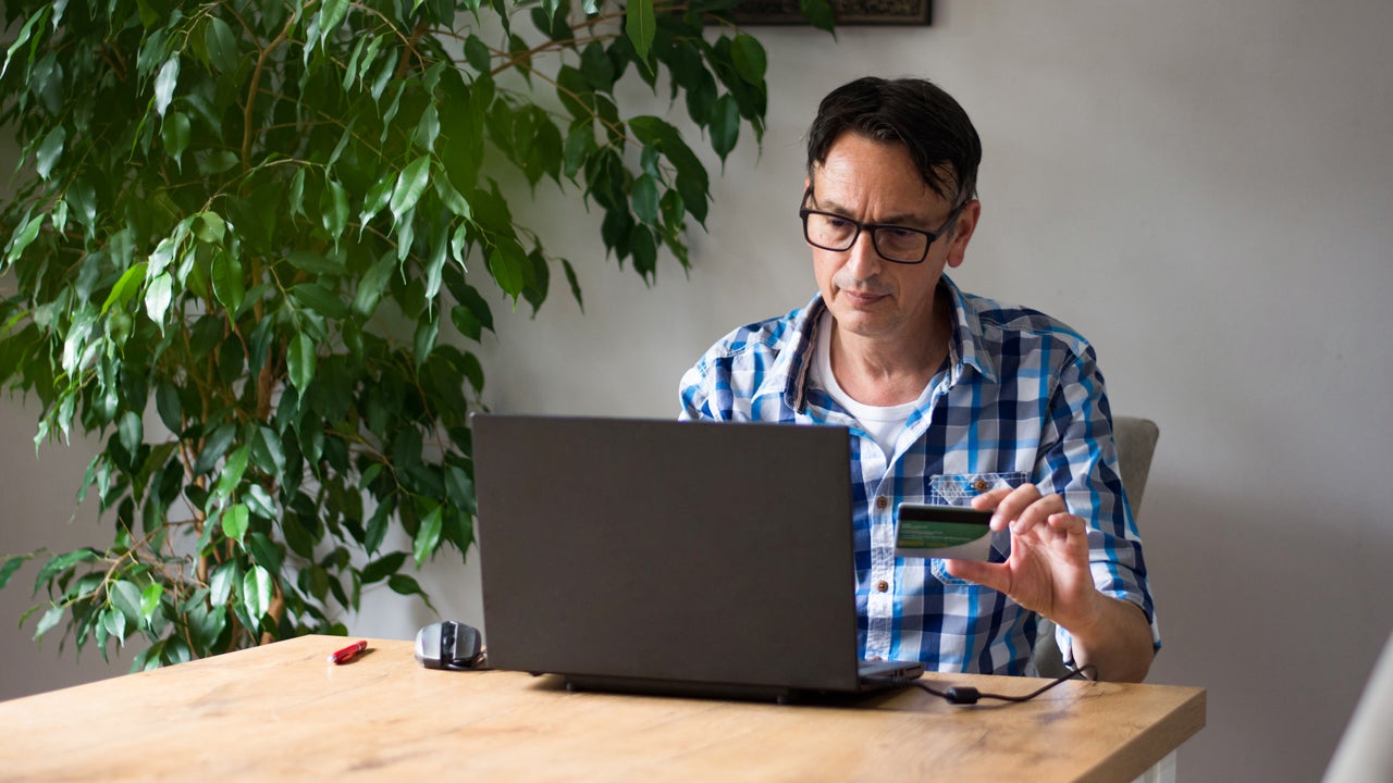 Man using credit card for online purchase