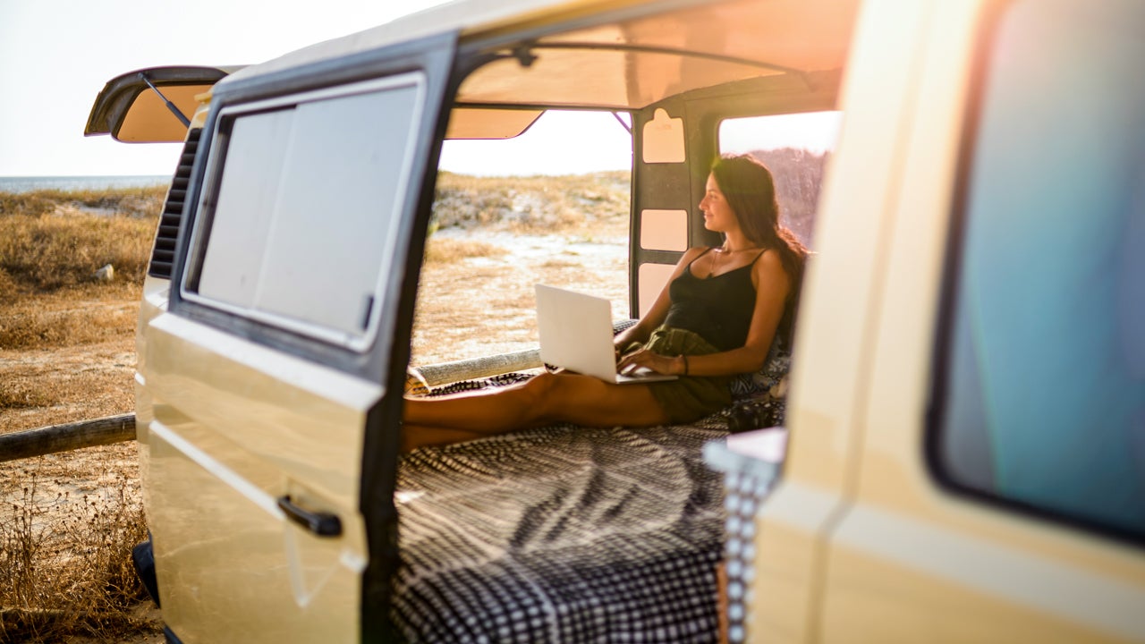 van door is open with a young lady inside viewing the sunset