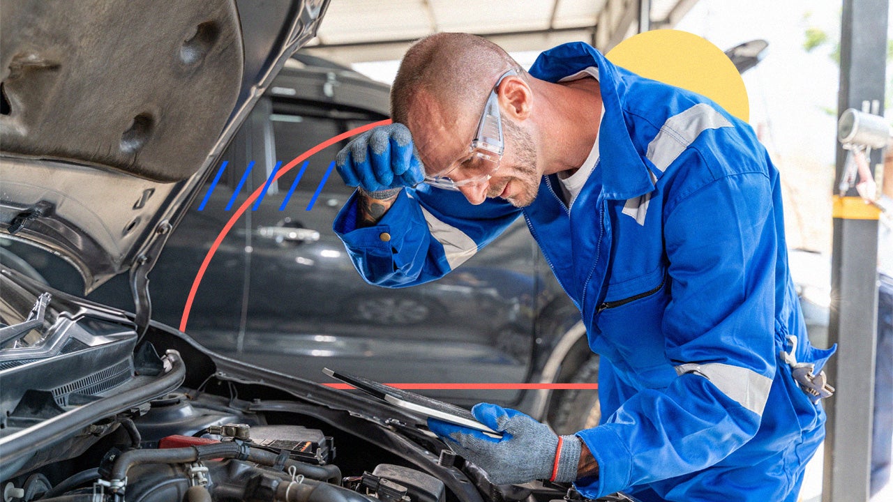 Mechanic looks into a car.