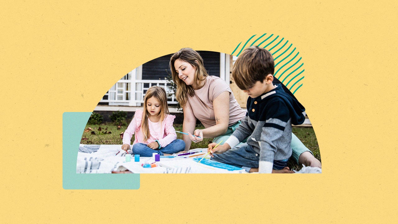 Woman and two children painting outside