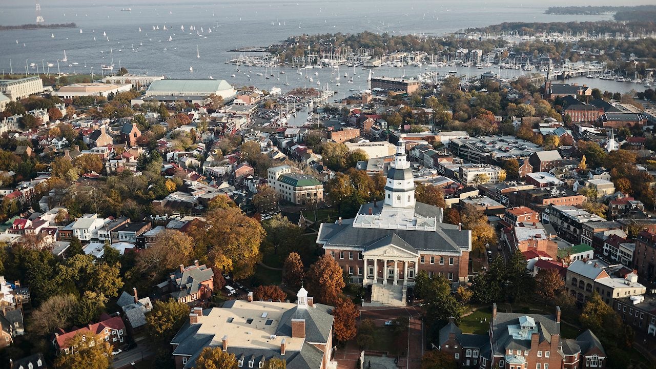 Aerial view of Annapolis, Maryland, including the historic state capitol building and sailboats in the harbor