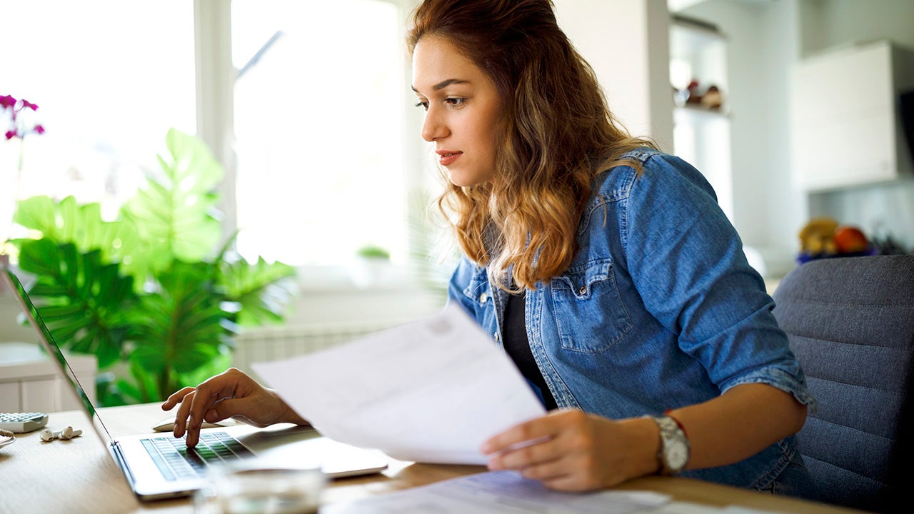 Serious young woman working at home