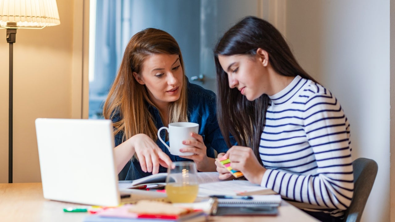 Mom helps daughter with homework