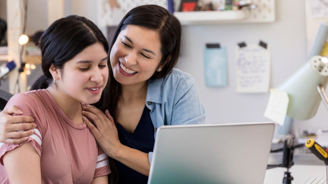 Older woman smiles at high school student