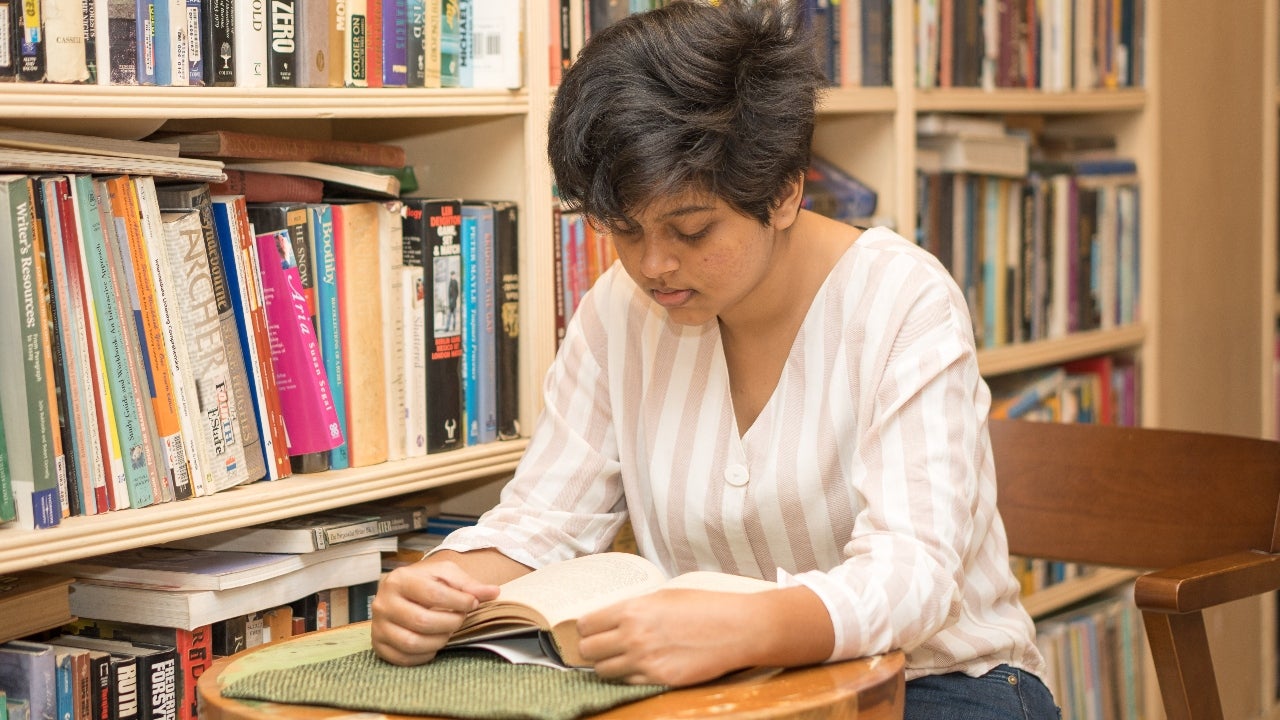 Student studies in a library cafe