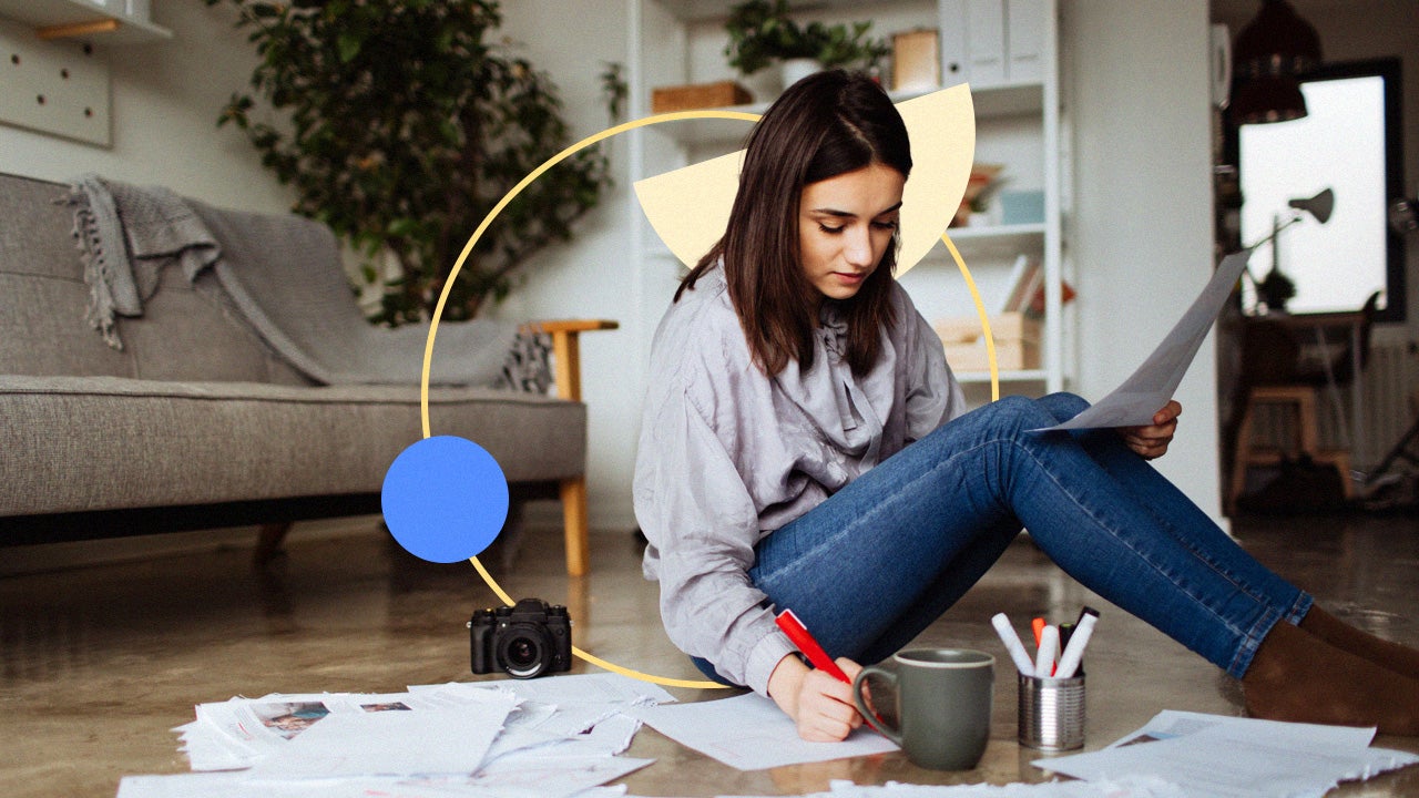 Woman sitting on a floor with many documents