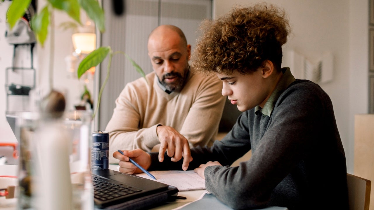 Father helps son with homework