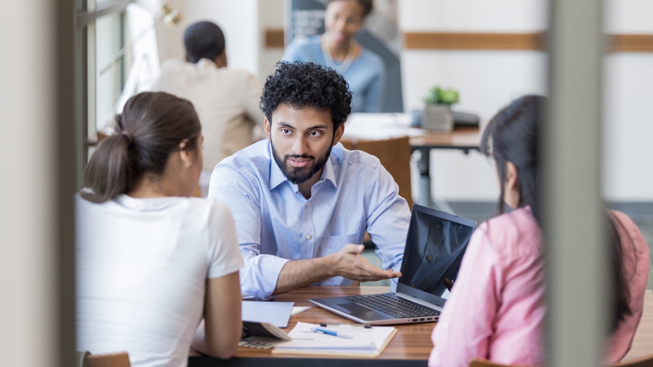 Personal banker instructs clients concerning online banking