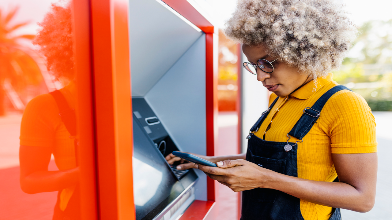 BIPOC woman using ATM