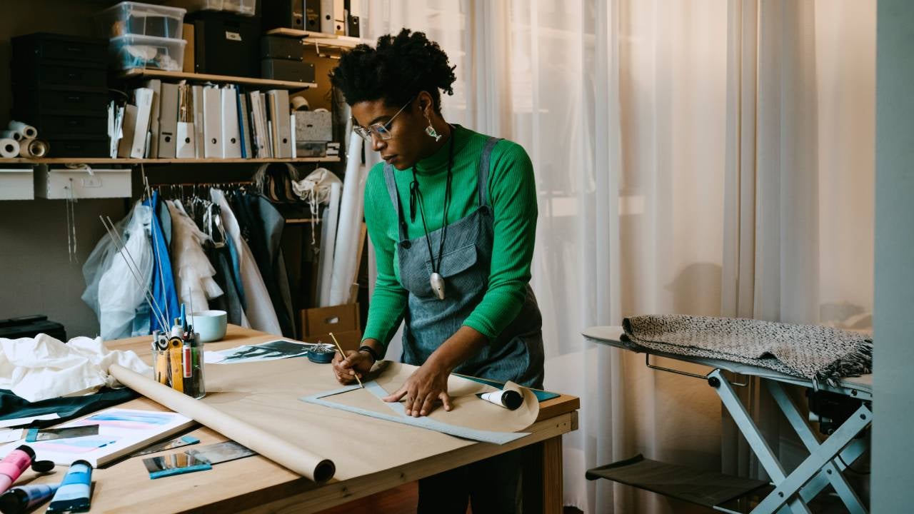 Woman doing craft at table in living room