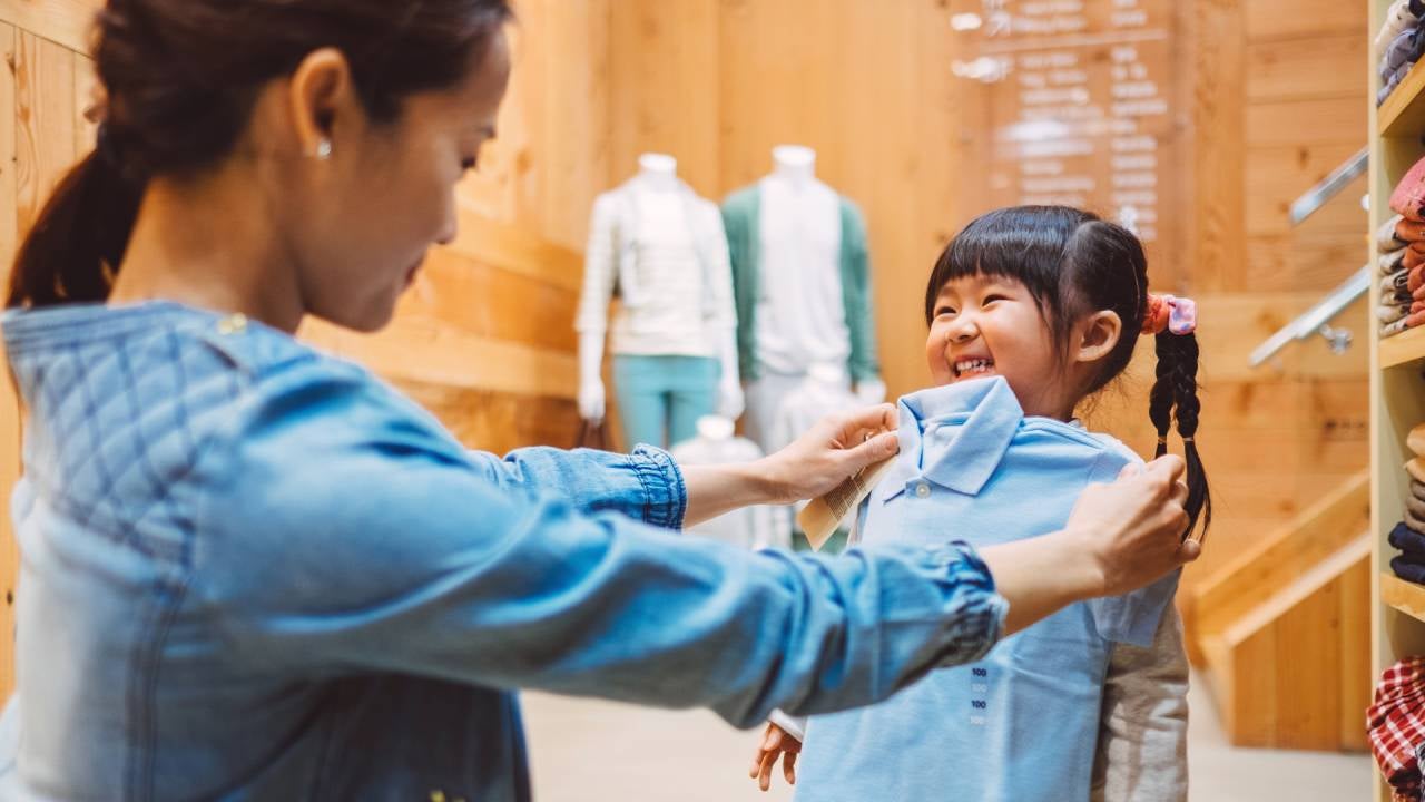 Woman shops for clothes with daughter