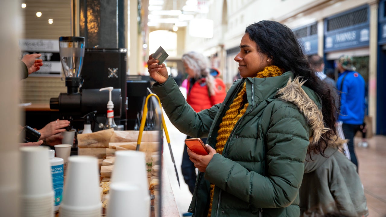 young woman paying for a coffee