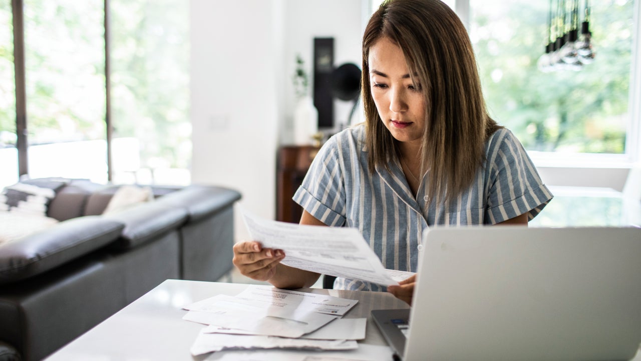 Woman paying bills at home