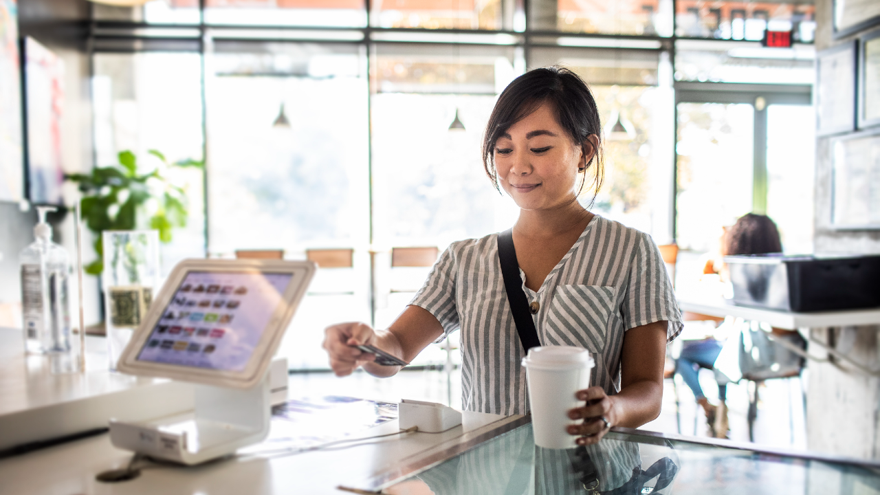 Woman pays with credit card at checkout