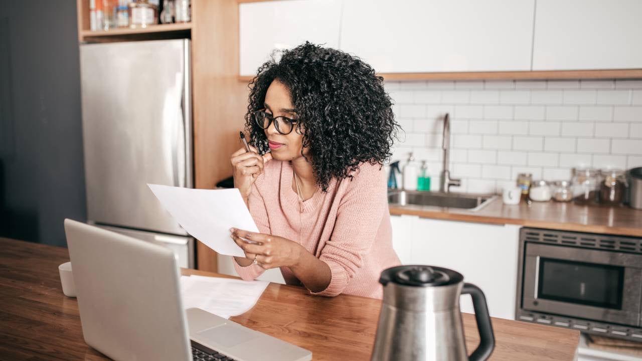 Woman planning expenses in the kitchen