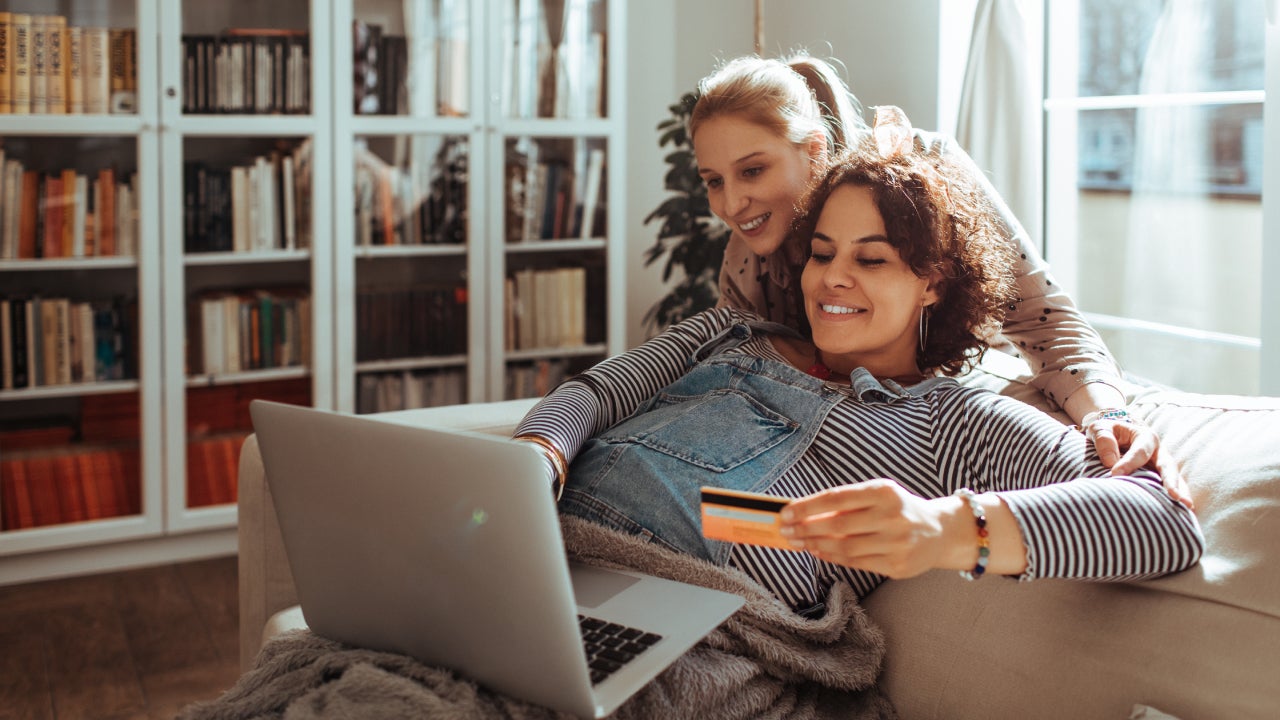 Close up of a female couple online shopping on their laptop