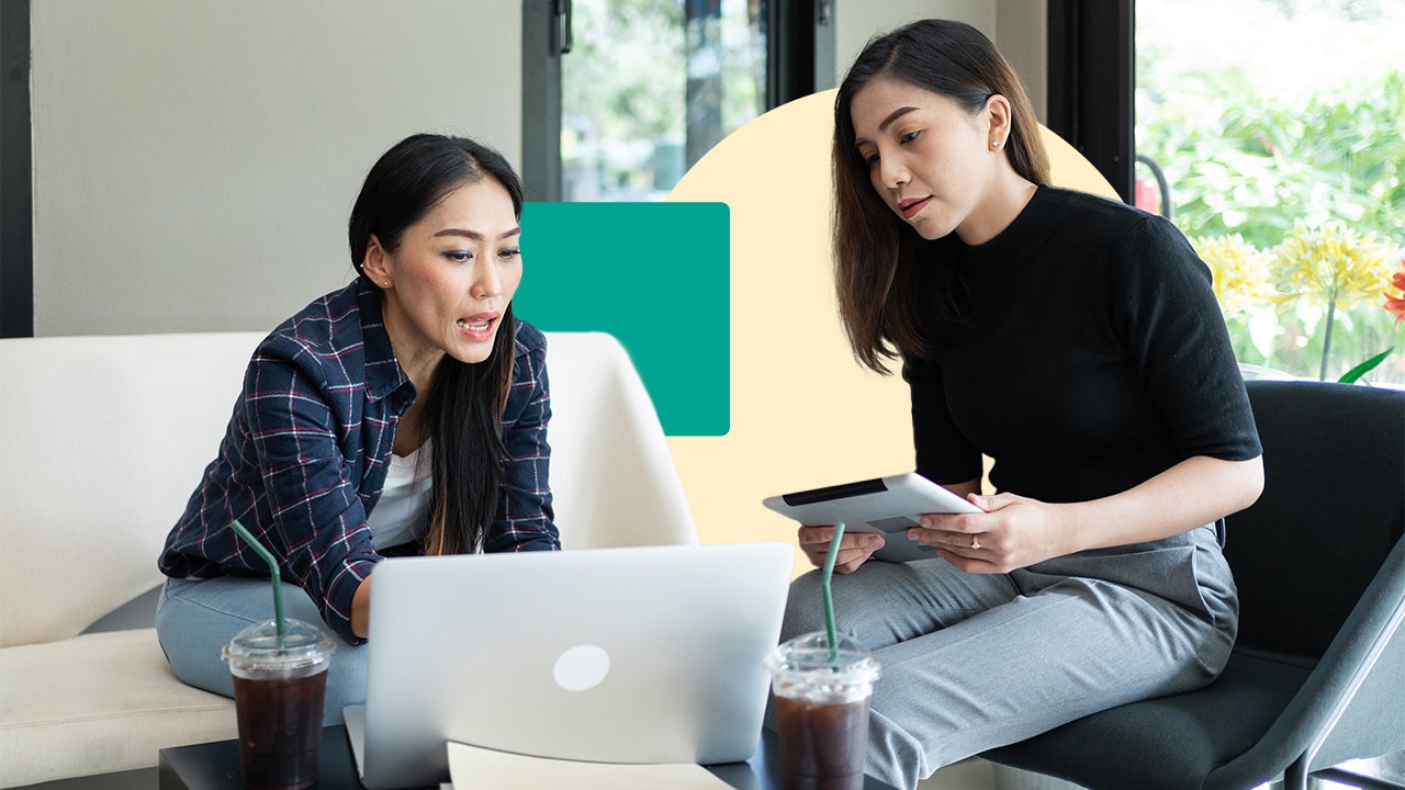 Two people reviewing their life insurance policies on a laptop.