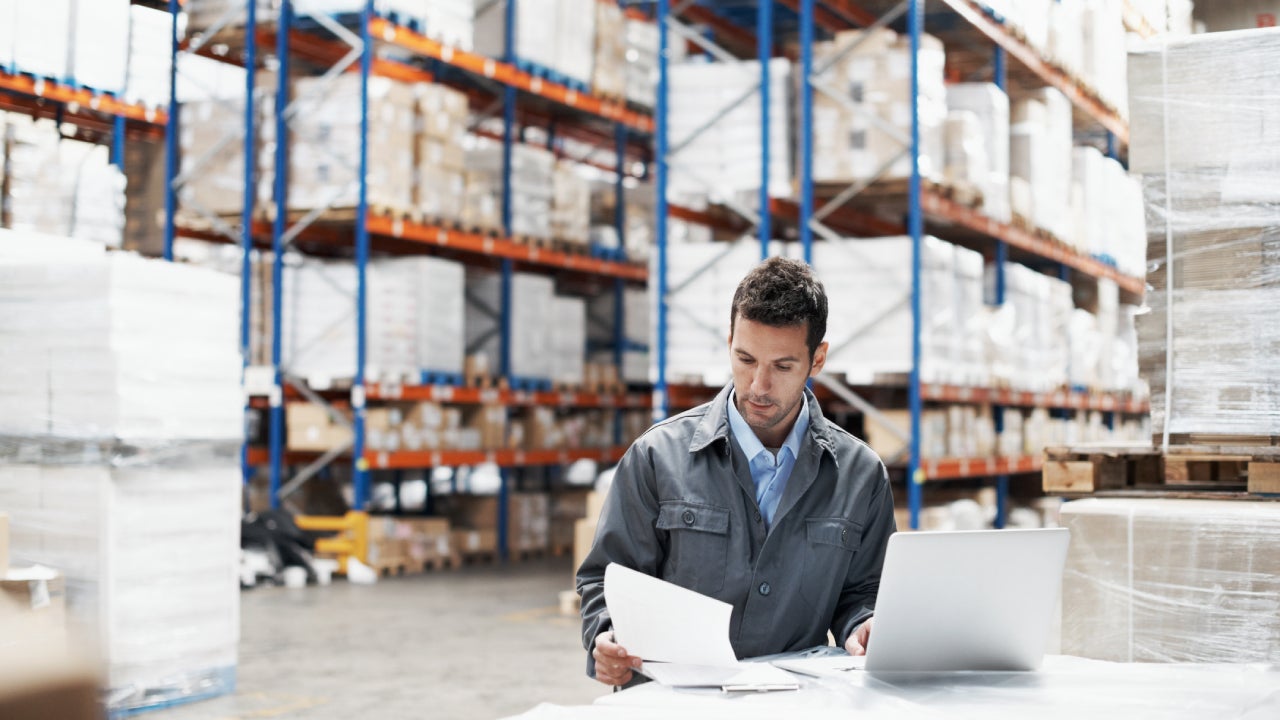 Man hard at work taking inventory in a warehouse