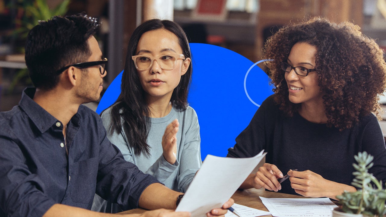 A couple going over tax documents with a professional.