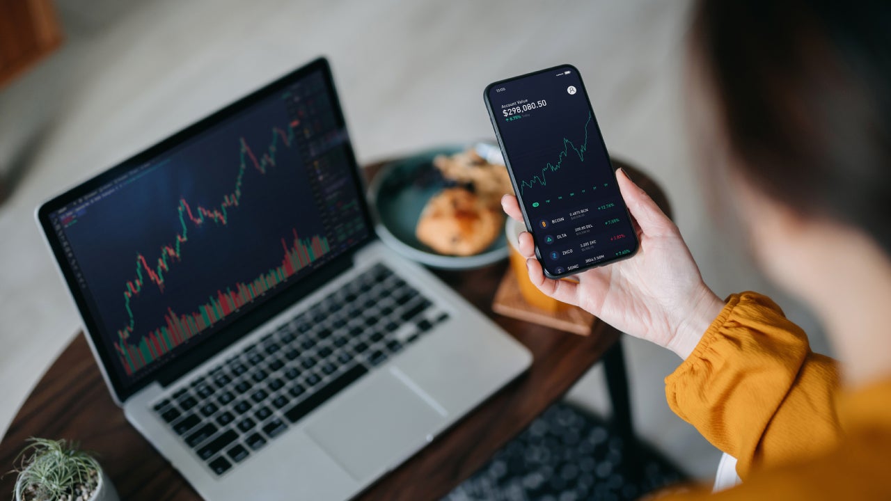 Woman looking at investing statistics on her cellphone