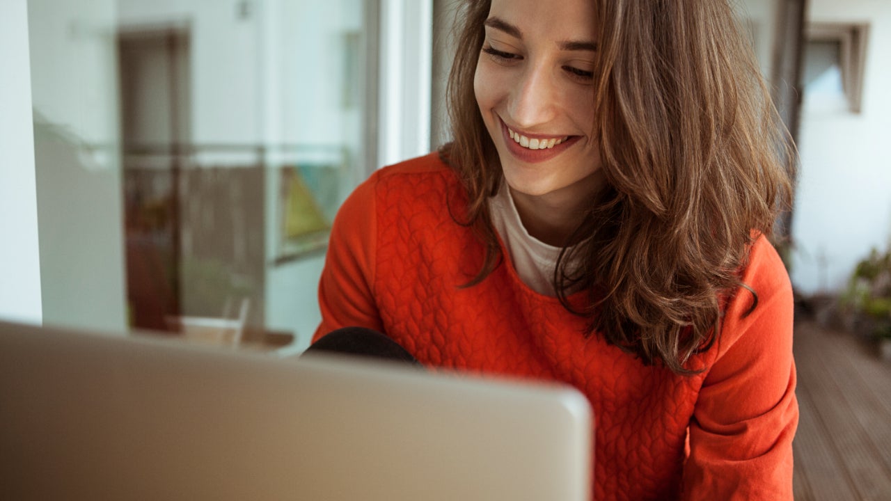 Smiling woman on laptop