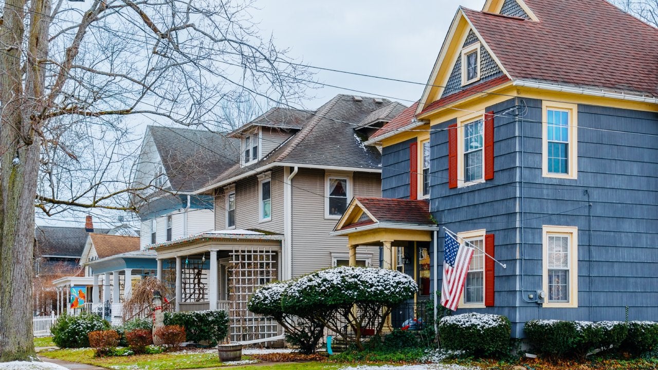 Street scene of a row of single family homes in Western New York after a light dusting of snow in early winter