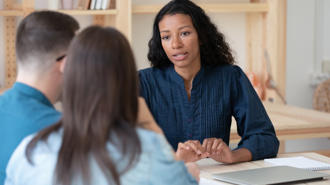 Biracial female consultant have meeting with couple clients