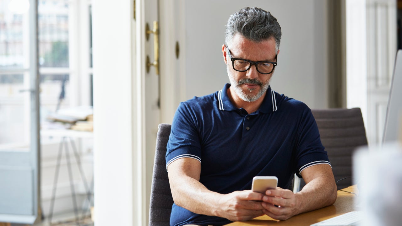 Businessman using mobile phone at desk