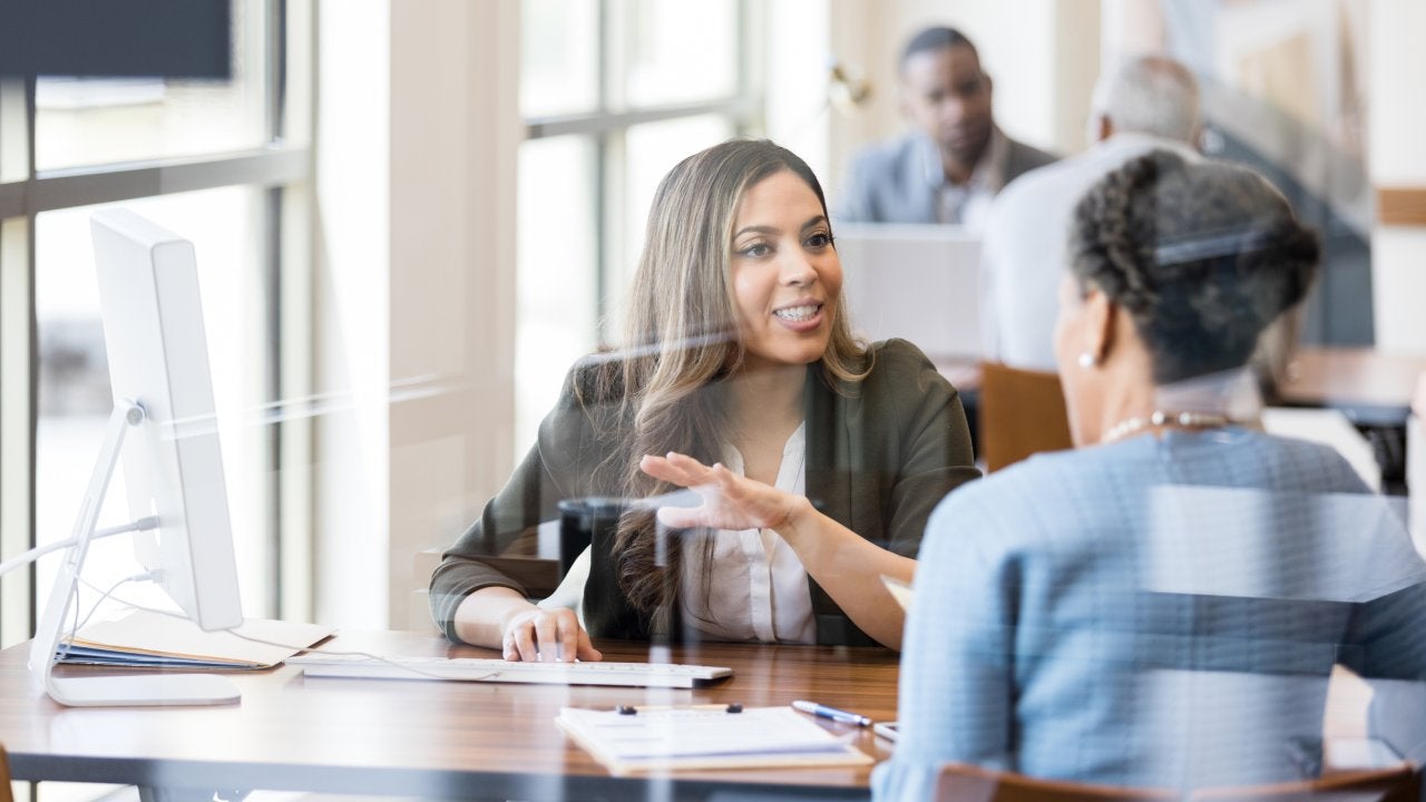 Banker discusses banking services to new customer