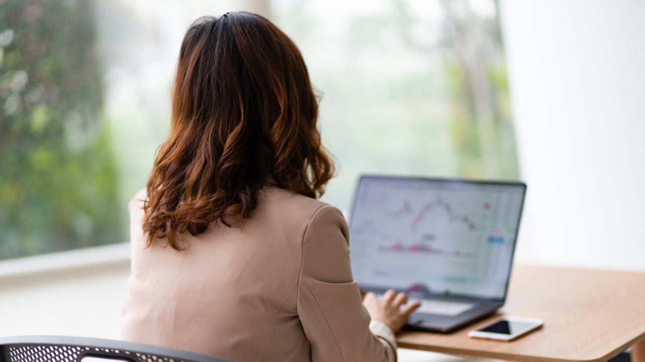 Woman facing away on her computer