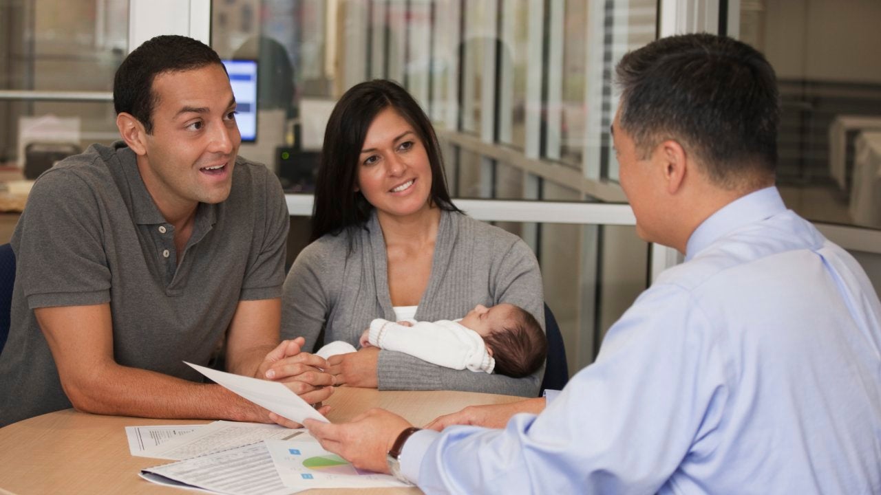 Couple speaking with a financial advisor