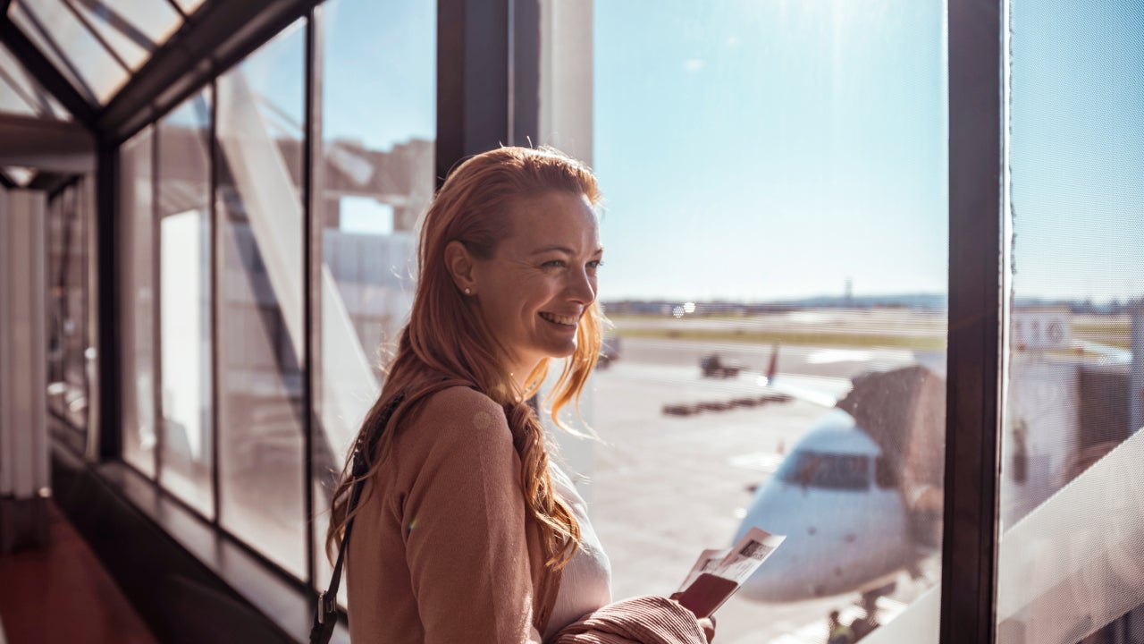 Young woman waiting to board the airplane