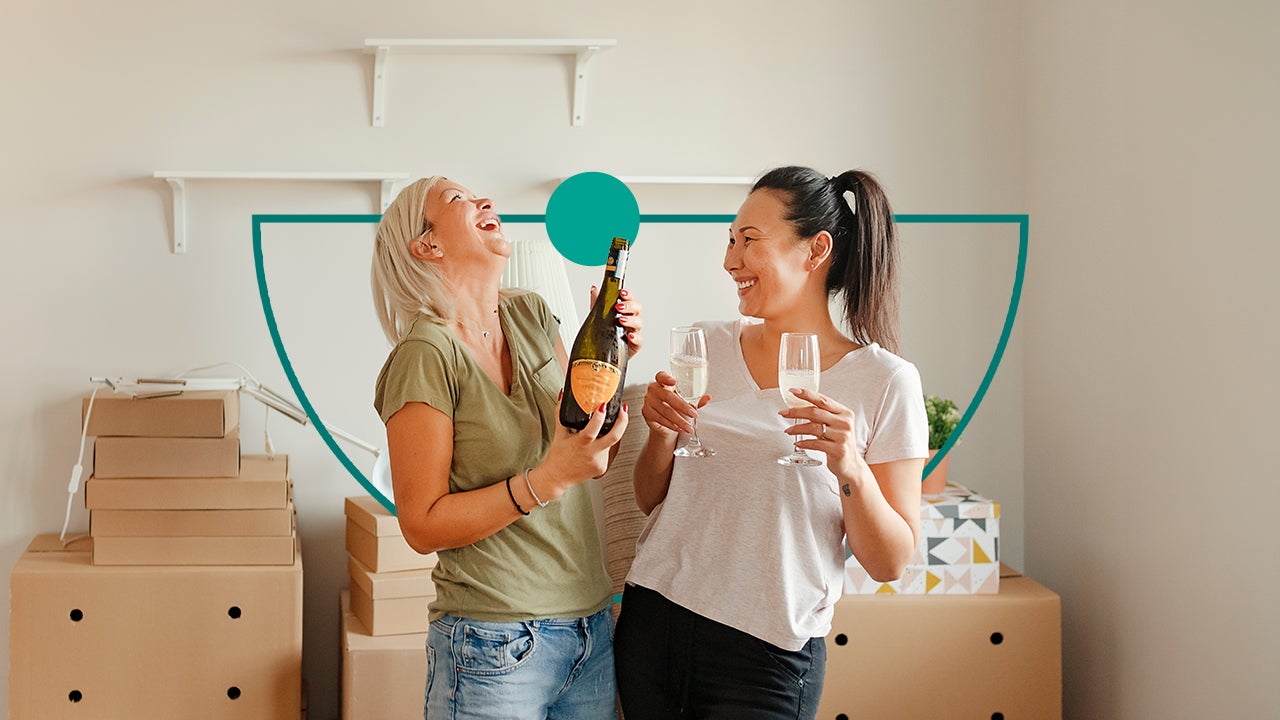 Two friends celebrating with a glass of champagne