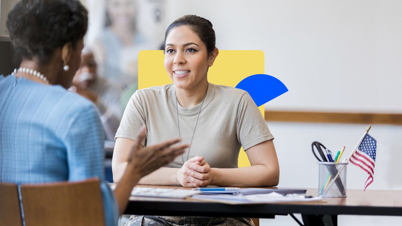 A smiling female military veteran speaks with a loan officer.